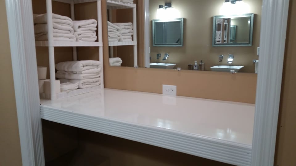 auxillary dressing area in hall bath with great light for makeup preparation.