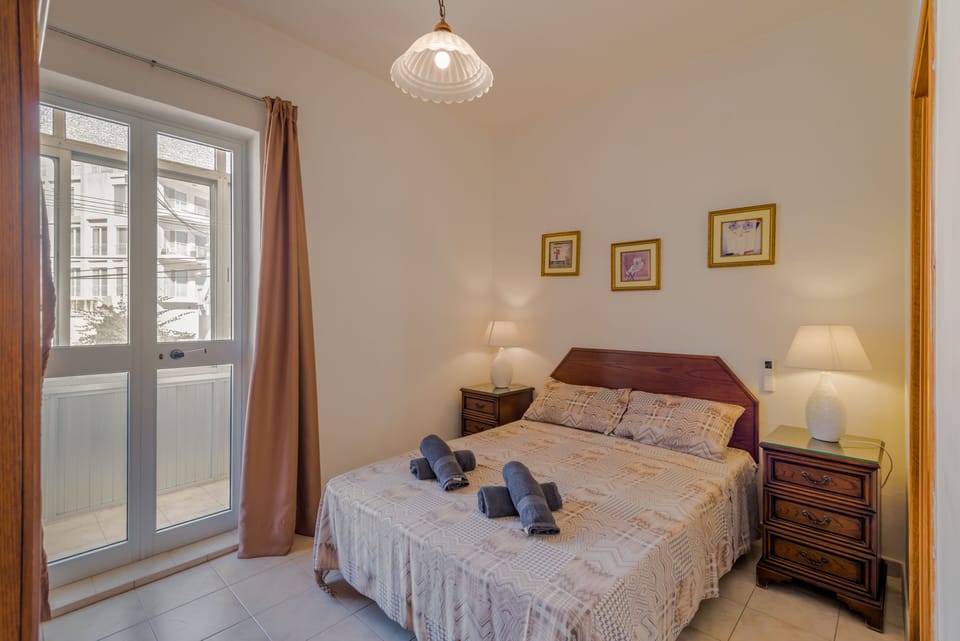Main Bedroom With Balcony And En-Suite Bathroom.