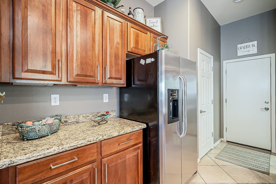 Granite countertops, large GE refrigerator/freezer, pantry- food prep equipment.