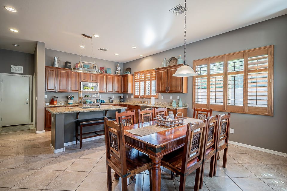 8 place dining table off of kitchen with additional seating at large island.