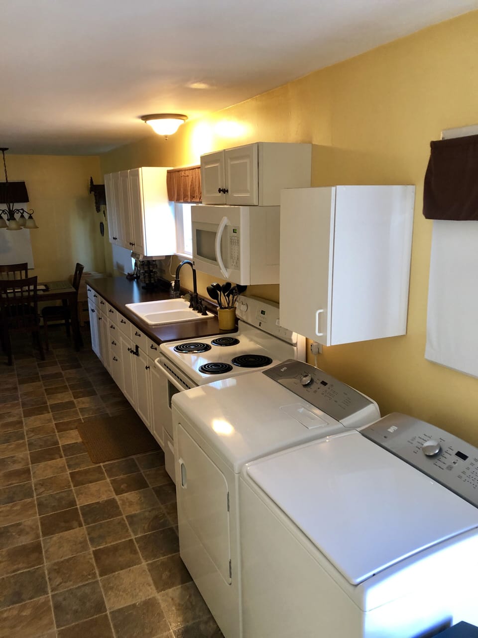 Kitchen with full size washer and dryer