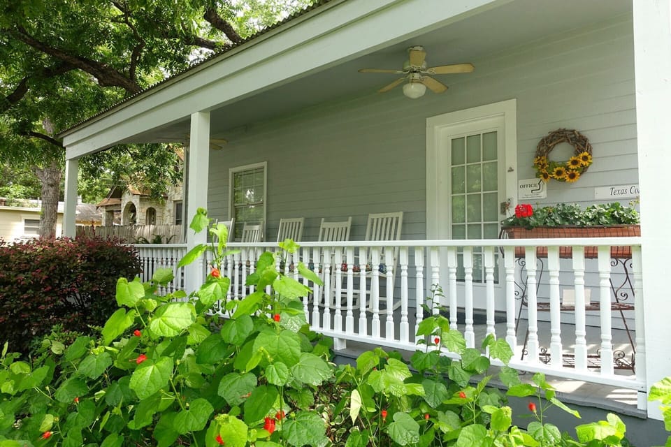 Texas Cottage private front porch with 6 rocking chairs