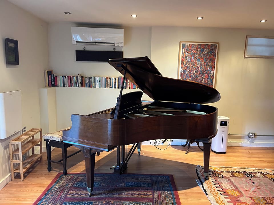 Baby grand piano in lower level