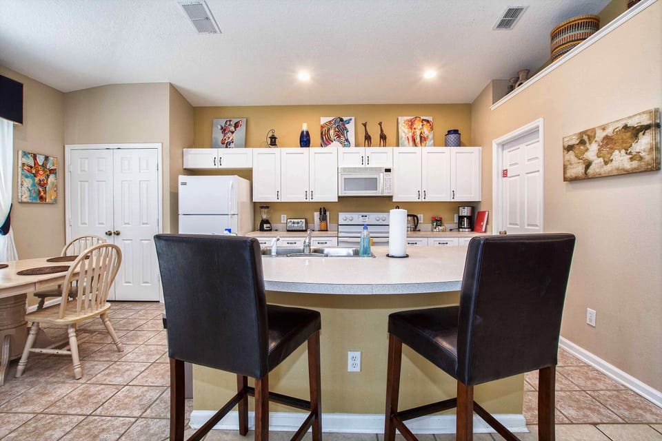 The kitchen with a couple counter seats.