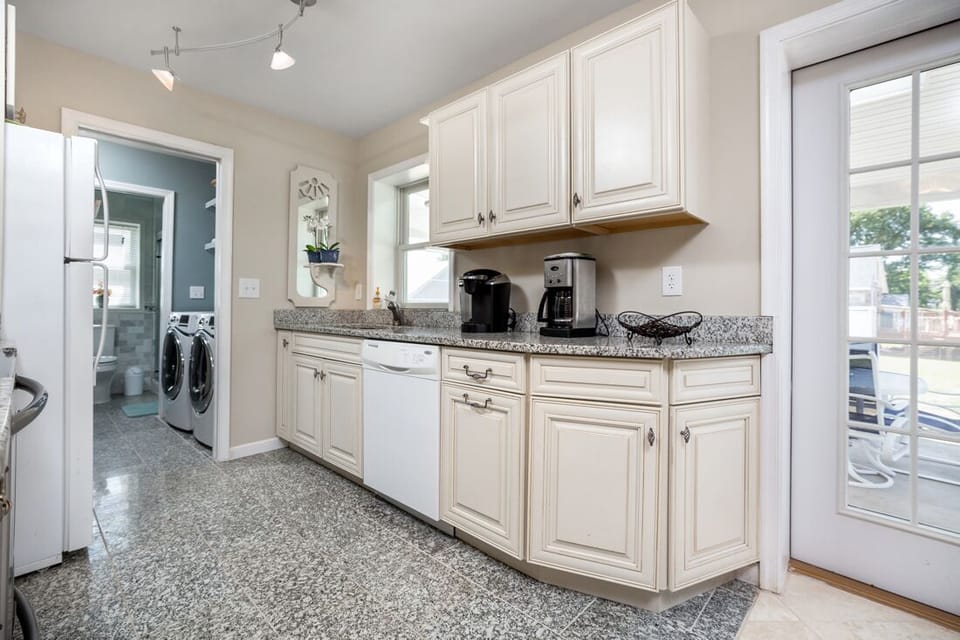 Gleaming Granite Countertrops and beachy white cabinets make cooking not such a chore.