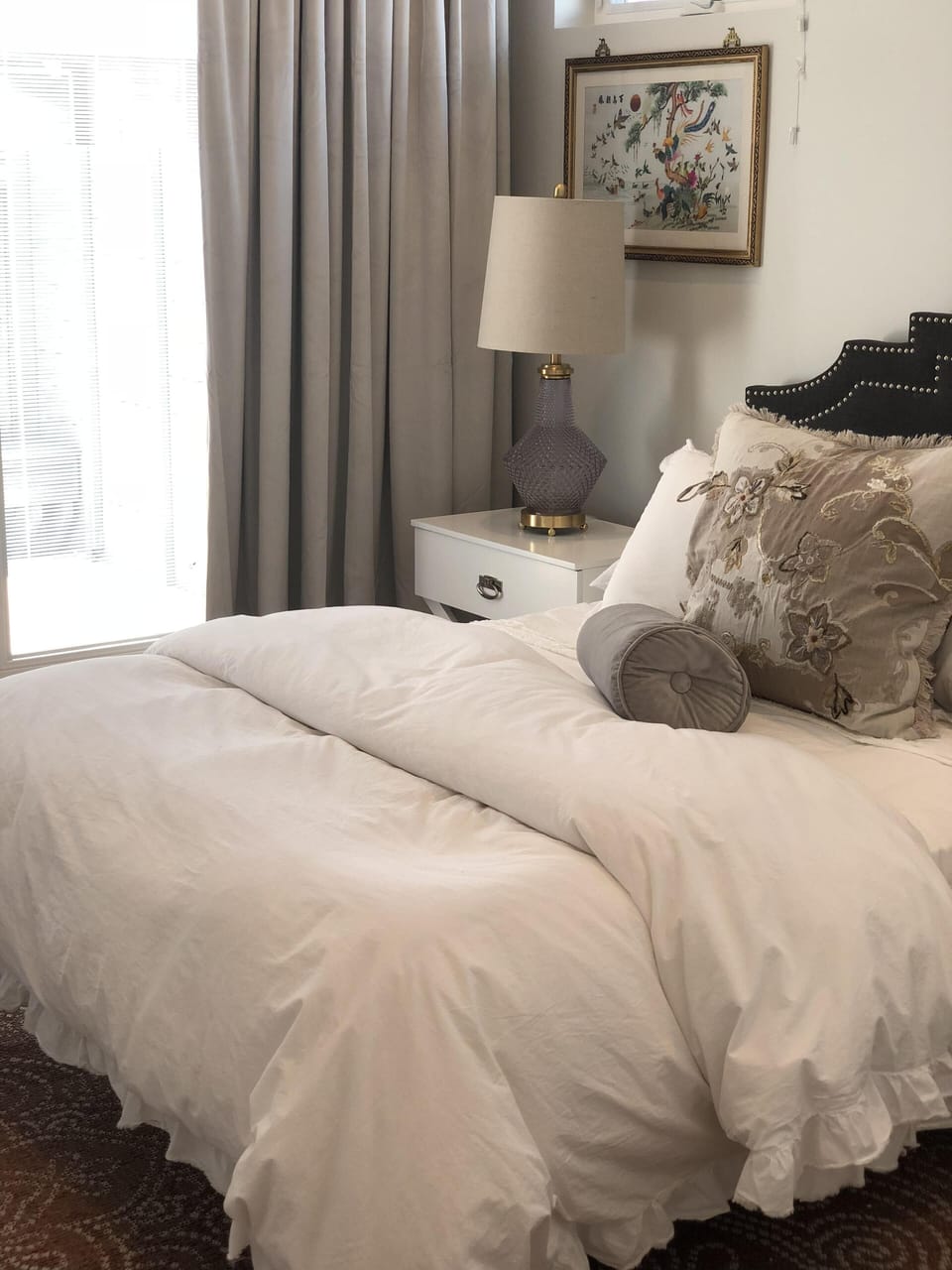 Master bedroom with luxurious, comfy bed, with French doors out to private patio