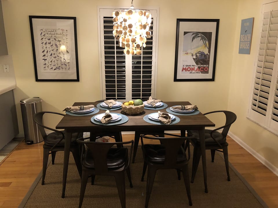 Sea shell chandelier and table for six. Addtl. seating in the porch.