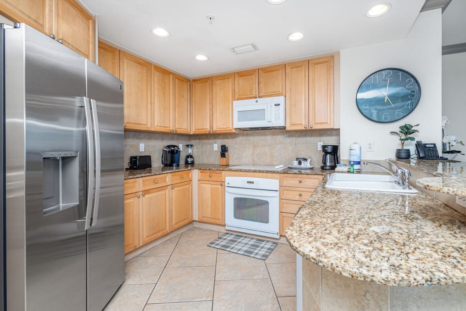 A fully equipped kitchen awaits your culinary adventures, with gleaming stainless steel appliances, ample counter space, and everything you need to prepare your favorite meals in comfort.
