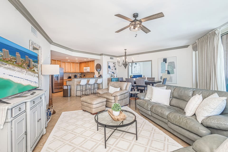 Step into your bright, open-concept retreat where soft beige tones and coastal charm invite you to unwind. The spacious living area flows seamlessly into a fully-equipped kitchen, perfect for gathering and making vacation memories.