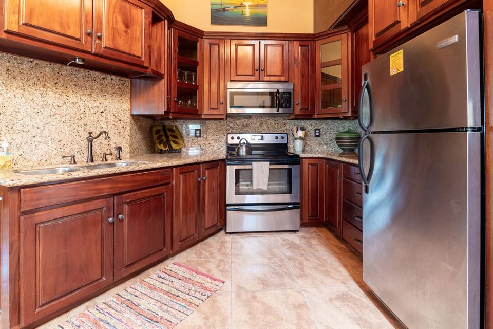Updated kitchen with granite countertops and stainless steel appliances