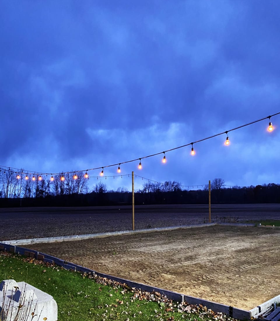 Outdoor bocci / cornhole game area with night lights and power for music 