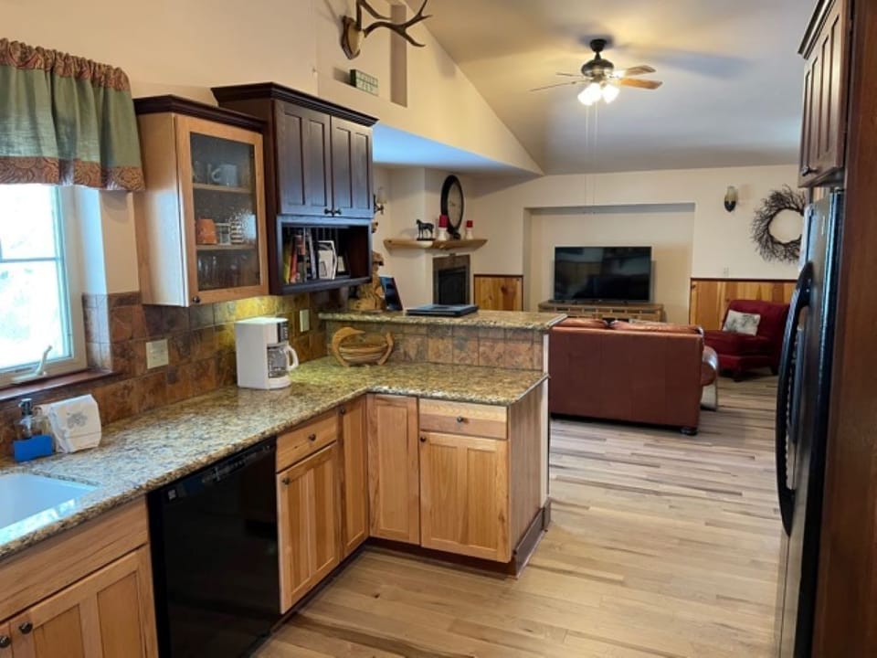 Fully stocked upstairs kitchen is open to living and dining areas