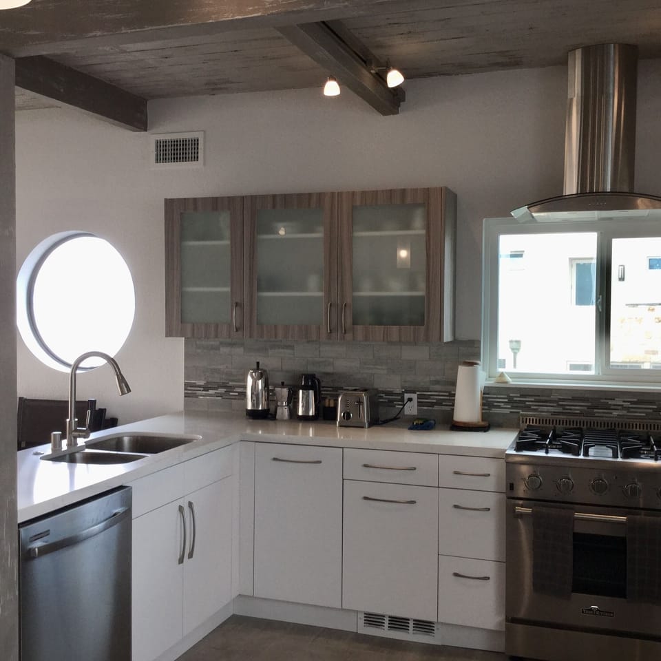 Large open kitchen with tons of cabinets and work areas