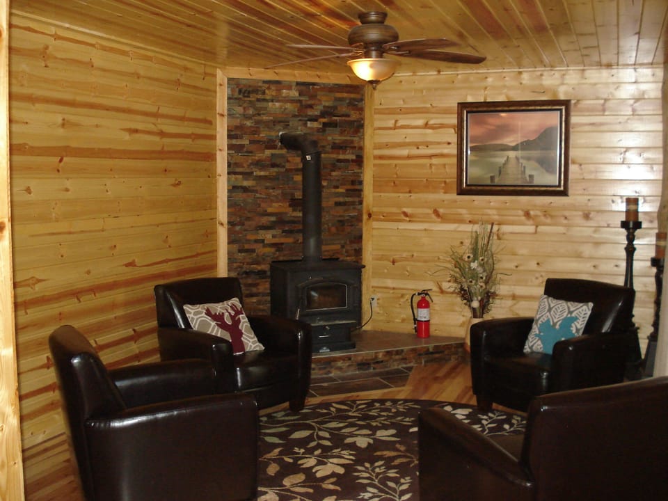 Sitting area off of main den.  Wood stove and a flat screen make for a cozy room