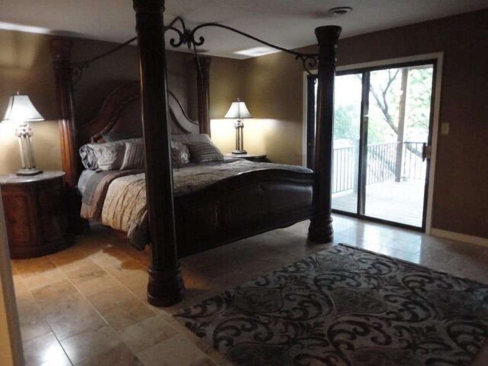 Master bedroom w/king sized bed & a huge view of the lake from the middle level.