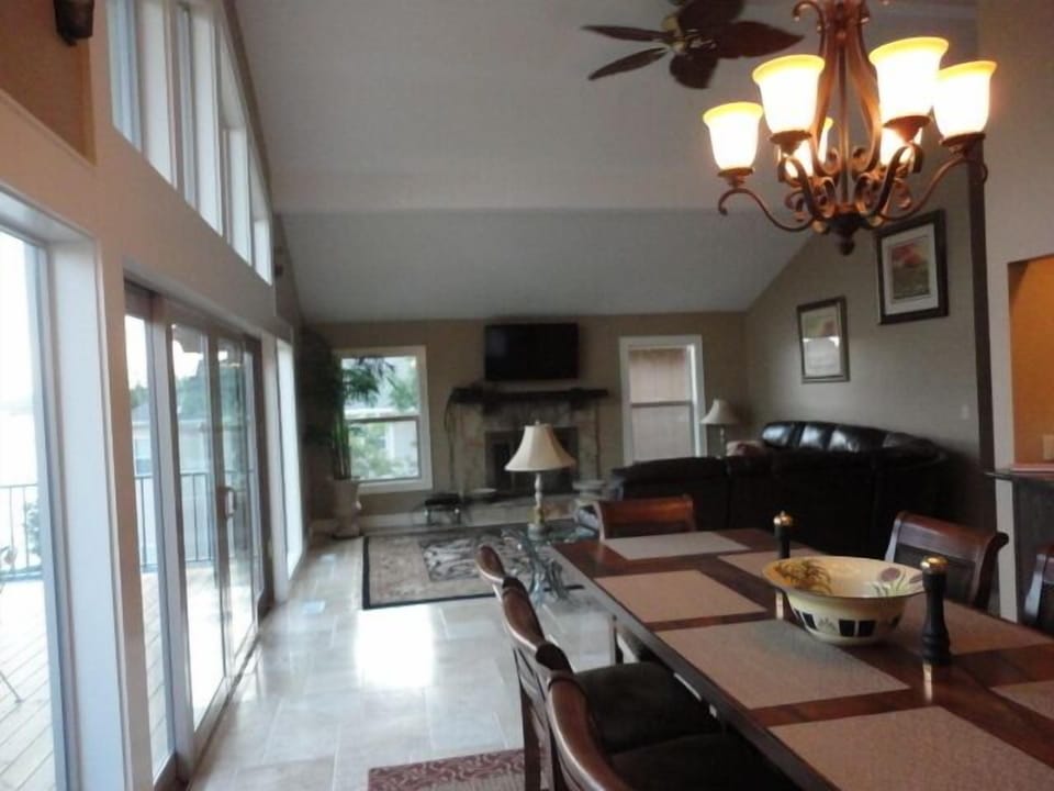 Vaulted living room with wood burning fireplace. Dinning room table for 8. 