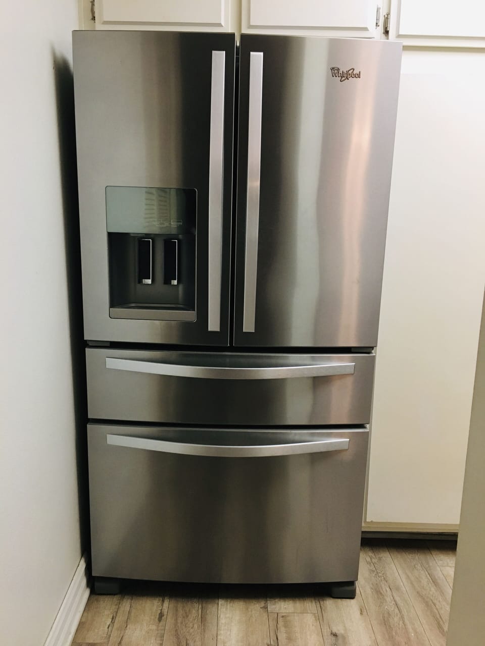 Refrigerator with automatic ice and water. White cabinets w/ quartz countertop. 