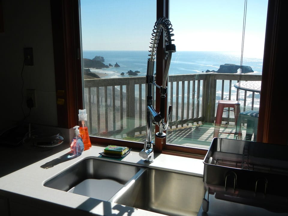 View of front deck while washing dishes; kitchen door to front deck on left.