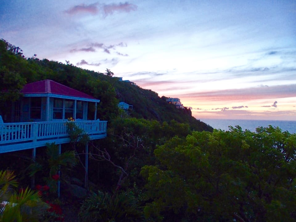 Deck and cottage with sunset in background