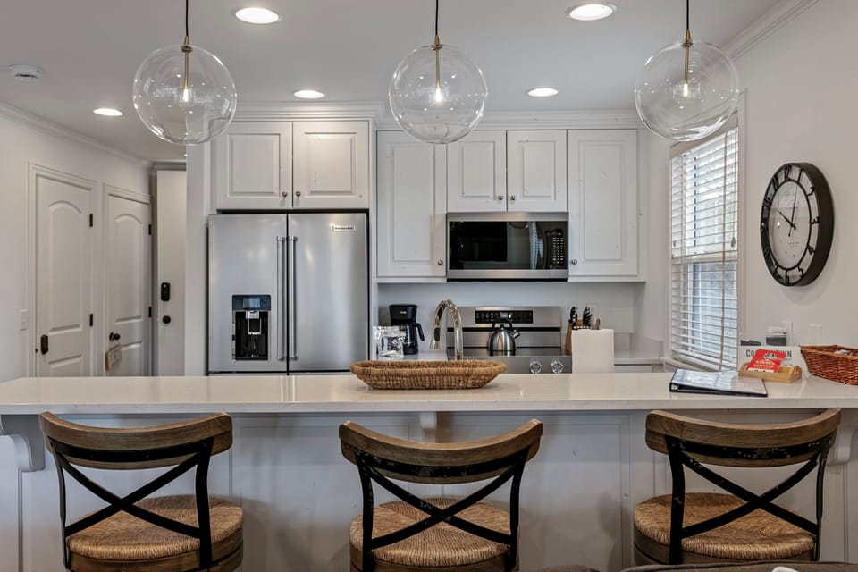 Remodeled kitchen at Three Kings 83 with quartz island and pendant lighting 