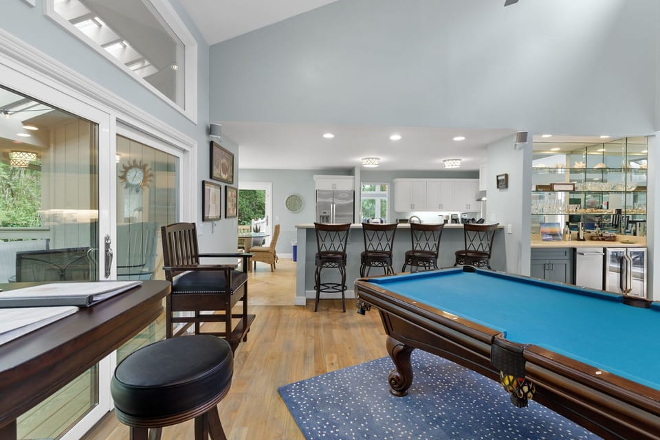 The billiard room has a full sized pool table & a 65" 4K TV along with a wet bar with ice maker & wine fridge. Great space to watch a game while playing a game of pool.
