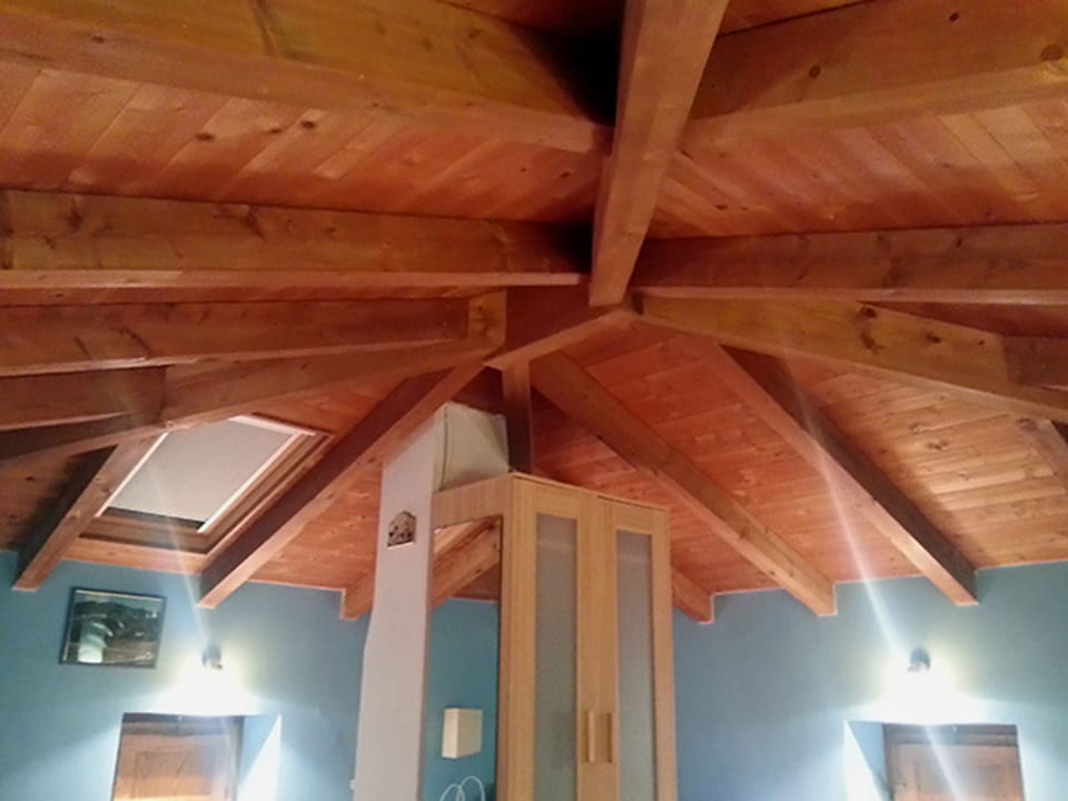 Wooden attic furnished with three single beds