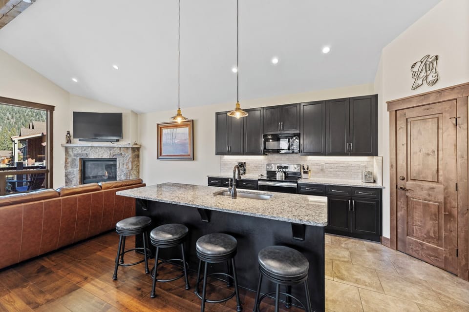 Your gourmet kitchen features granite counters, stainless appliances, and bar seating perfect for morning coffee or evening conversations.