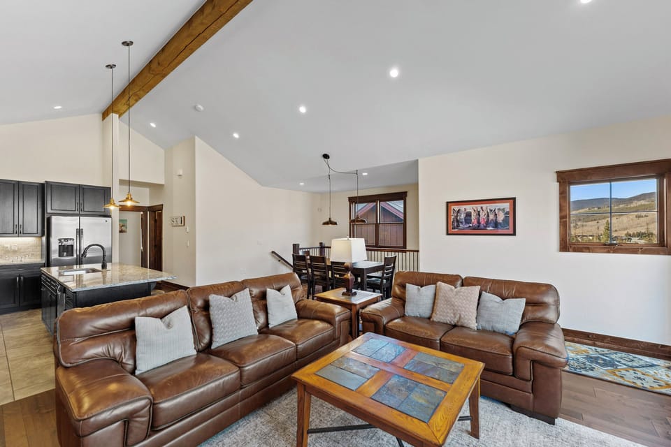 Sink into plush leather sofas in your open-concept living space with mountain views and rustic charm.