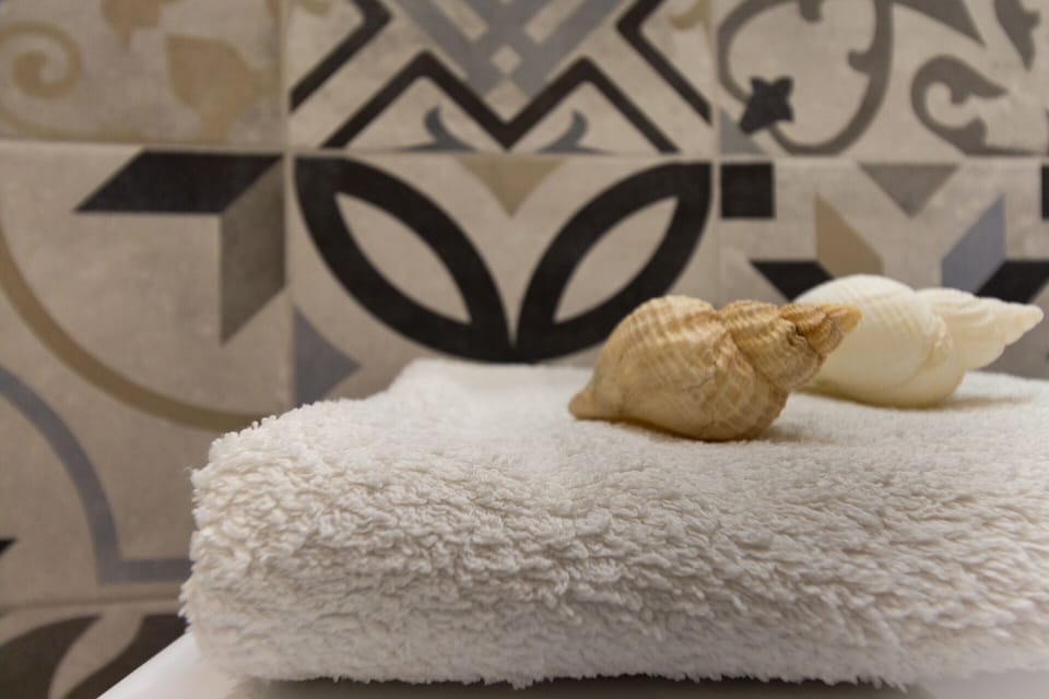 Quadruple Room, 2 Bedrooms | Bathroom | Shower, rainfall showerhead, free toiletries, hair dryer