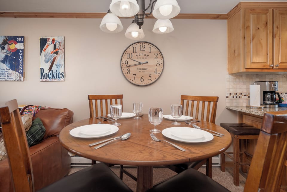 Gather around your cozy dining table for memorable meals together, with warm wood tones creating the perfect mountain lodge atmosphere.