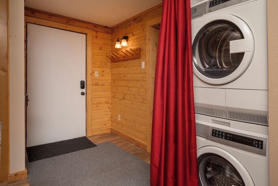 Your in-unit laundry facilities make packing light a breeze, with stacked washer and dryer tucked behind a cheerful red curtain.