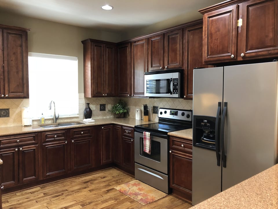 Fully stocked kitchen with small appliances, cookware, and table service for 12.