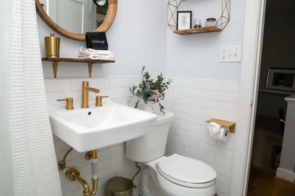 Newly remodeled bathroom with gold fixtures.