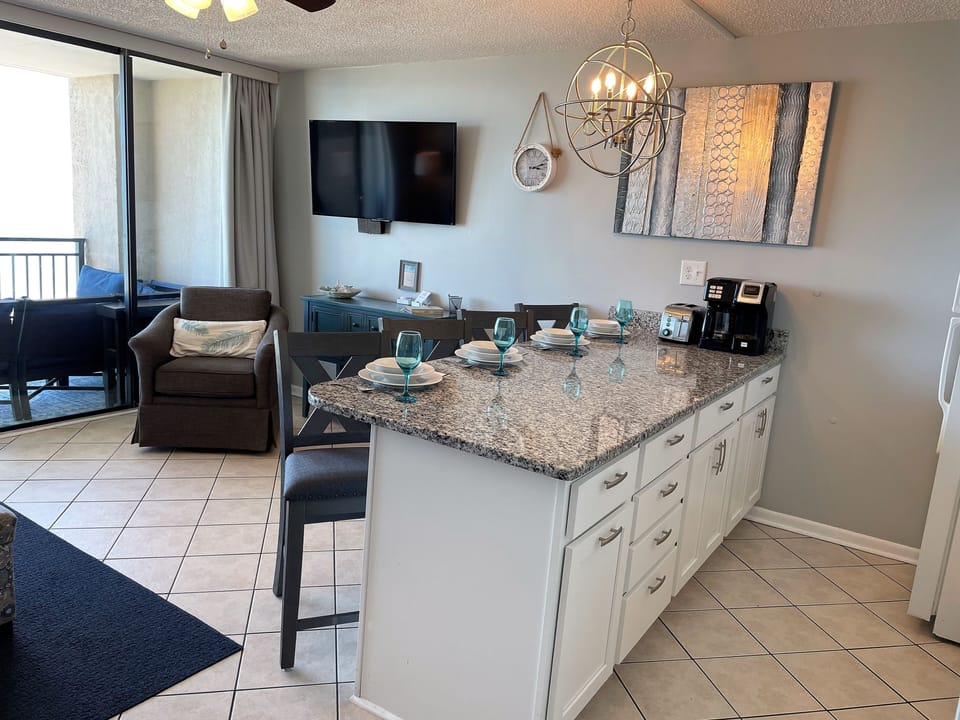 Large kitchen peninsula with plenty of counter space. Coffee pot and toaster.