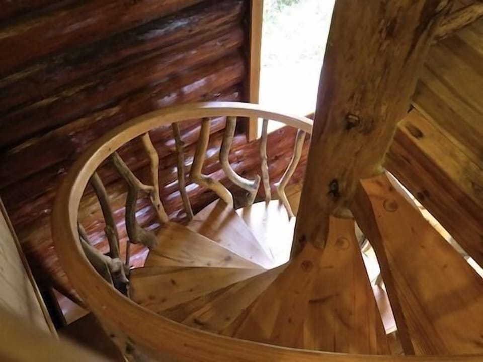 Log staircase leading to the loft and bedroom on 2nd level