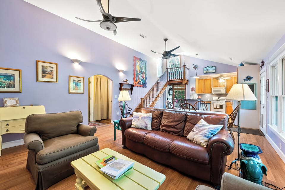 Living room, stairs lead to attic storage area, all living spaces on first floor