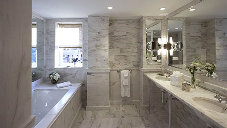 Bathtub, designer toiletries, hair dryer, bathrobes