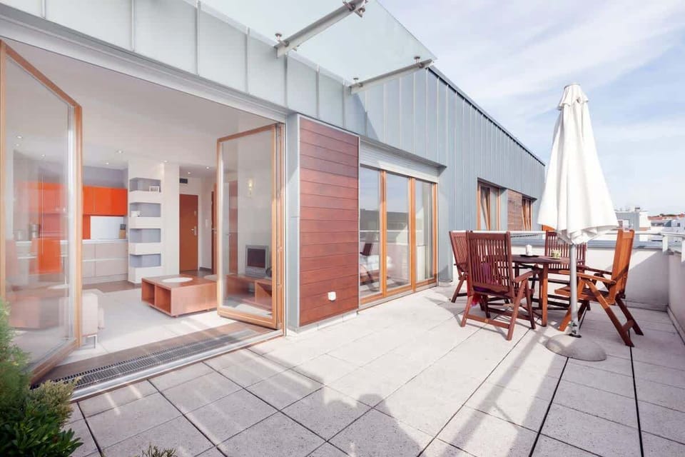 An outdoor seating area on the terrace with table and chairs, ideal for enjoying fresh air and outdoor dining.