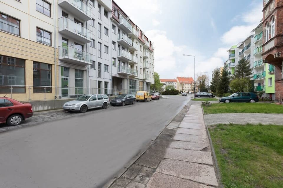 White and modern property building located near the park and the beach.