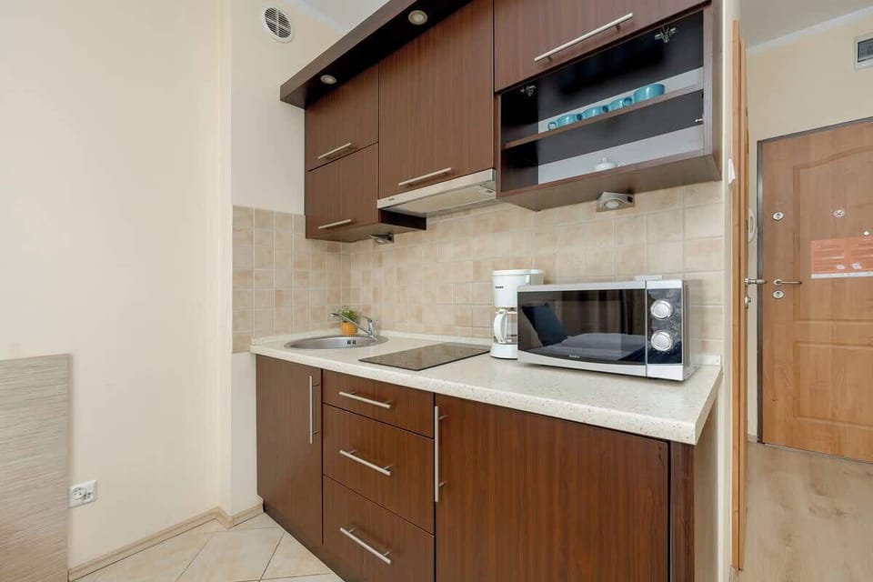 Functional kitchenette with brown cabinets.