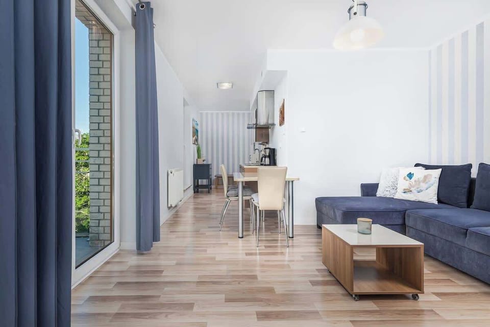 Stylish and comfortable living room with coffee table, dining area, double sofa bed and functional kitchenette.