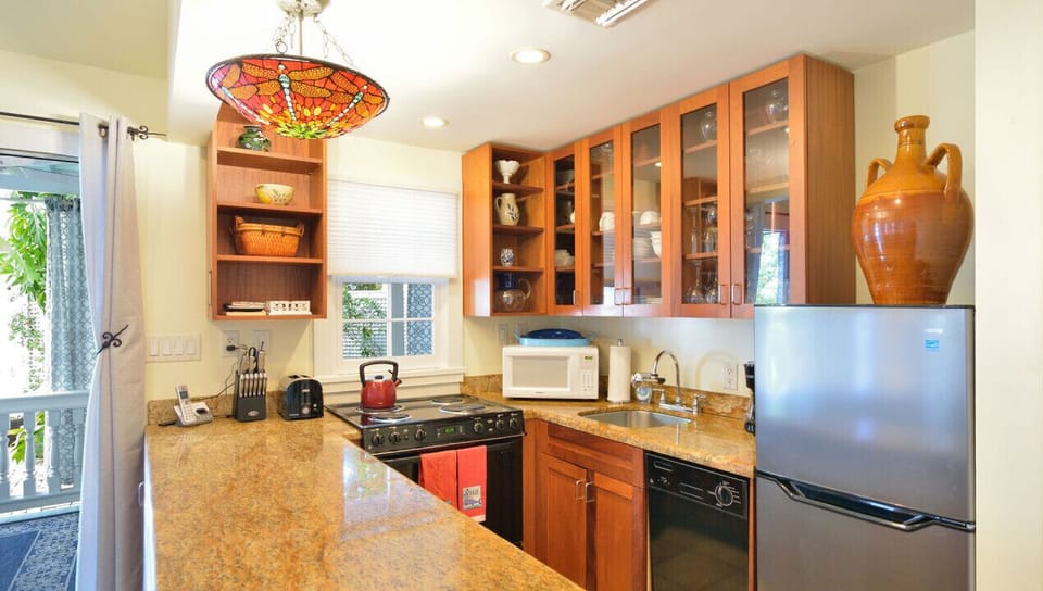 Open Concept Kitchen Stocked with Cooking Utensils