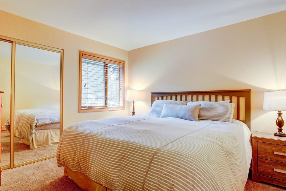 The front bedroom downstairs with kingsize bed and smart TV.  There are USB ports built into the back of the night stands.