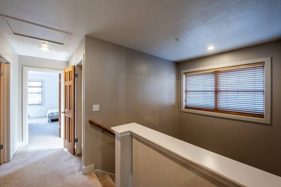 Upstairs hall / landing; master bedroom behind you, looking toward bedroom 2 ahead and  Bedroom 3 to the right.