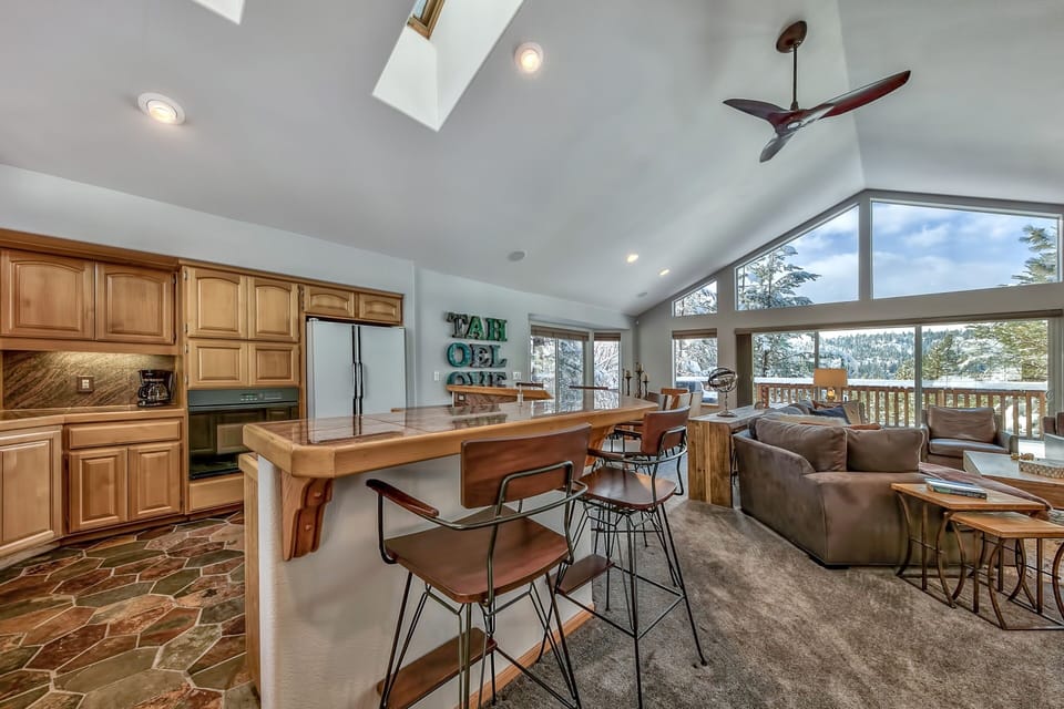Enjoy your morning coffee in this bright, open-concept kitchen that flows seamlessly into the cozy living area with stunning mountain views.