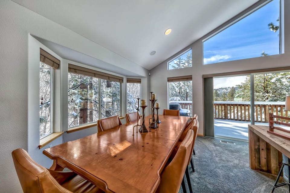 Your elegant dining space features stunning winter views through panoramic windows, perfect for memorable meals with loved ones.