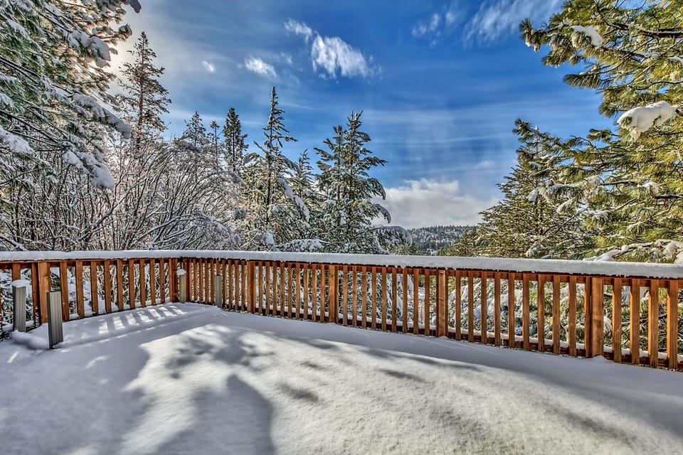 Step onto your private snow-covered balcony and breathe in the crisp mountain air while enjoying breathtaking winter forest views.