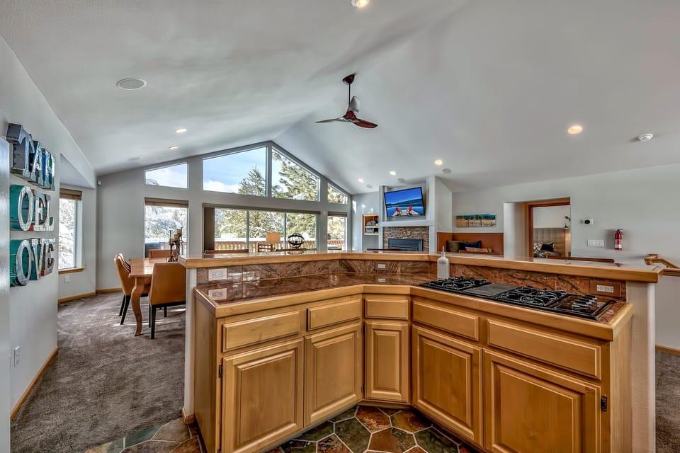 Your spacious kitchen opens to stunning mountain views, featuring granite counters and gas stove perfect for memorable meals.