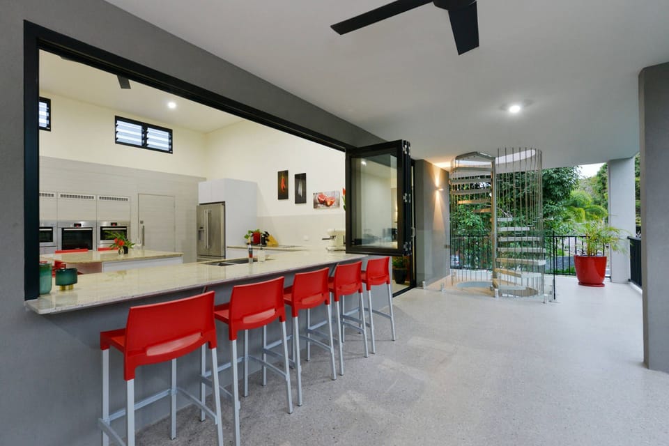 The kitchen servery opens to the expansive balcony.