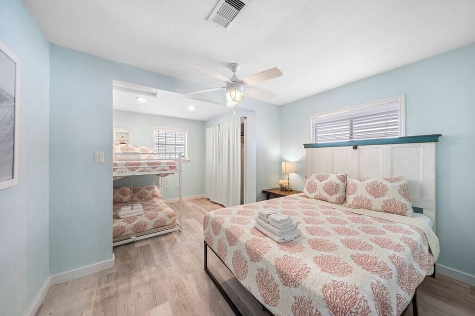 Experience the perfect blend of elegance and practicality in this bedroom with a queen bed and a full bunk bed